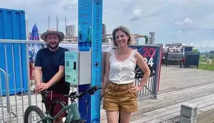 Image d'un homme, une femme et d'un vélo avec une borne petit format
